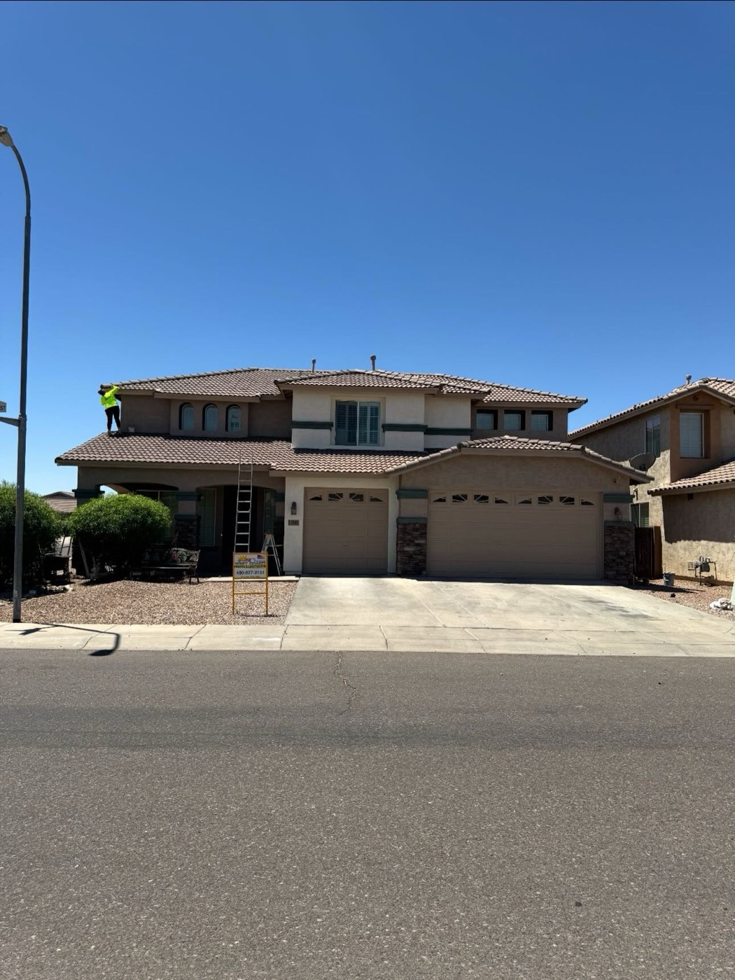 Exterior paint color samples tested on a stucco wall