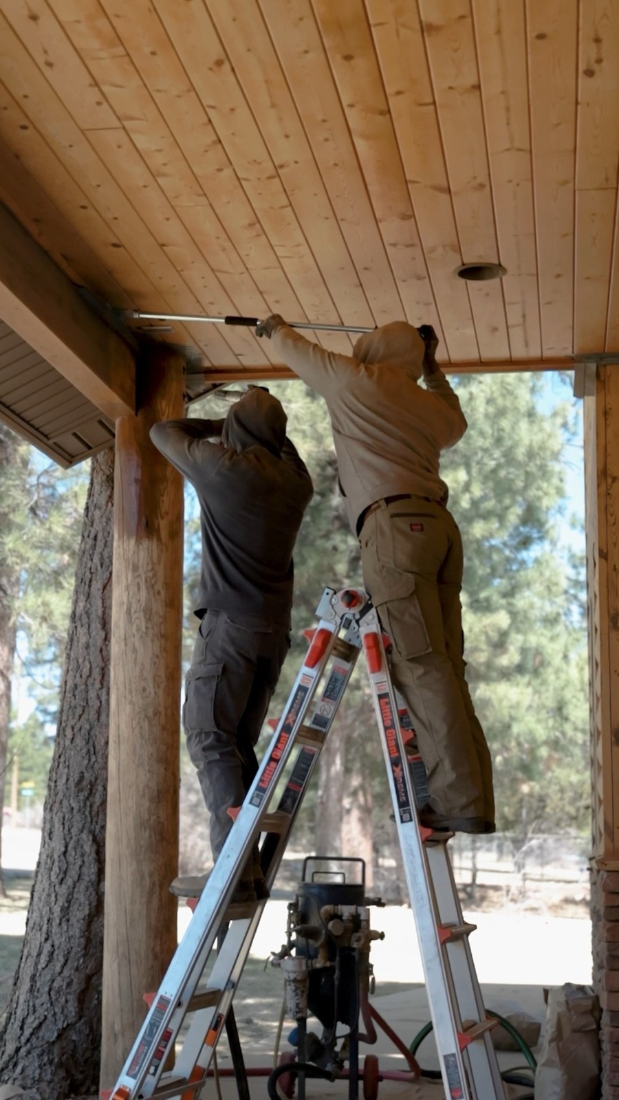 Painter prepping and priming an exterior wall before painting