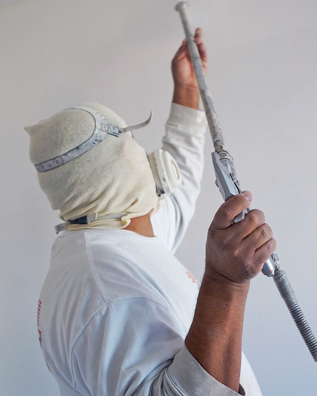 Interior painting crew spraying a ceiling